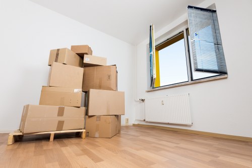 Local movers handling furniture in a Brompton street setting