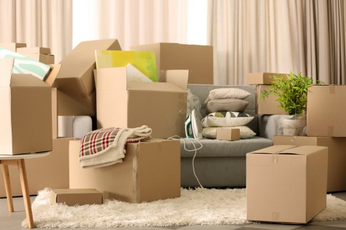 Movers handling boxes and furniture in a Brompton property