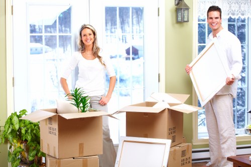 Professional movers transporting office furniture in Brompton