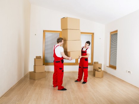 Team lifting a heavy item with coordinated manual handling